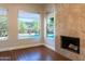 Living room with a fireplace and lots of windows with a pool view at 9571 E Nittany Dr, Scottsdale, AZ 85255
