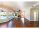 Bright living room featuring hardwood floors, fireplace, and large windows with pool views at 9571 E Nittany Dr, Scottsdale, AZ 85255