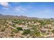 Aerial view of the property showcasing the surrounding desert landscape and mountain views at 11008 N 119Th Pl, Scottsdale, AZ 85259