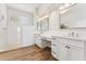 Bright bathroom with white cabinetry, double sinks, and a spacious walk-in shower at 11008 N 119Th Pl, Scottsdale, AZ 85259