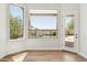 Bedroom showcasing pool views through expansive windows, complimented by a door leading to the outside at 11008 N 119Th Pl, Scottsdale, AZ 85259