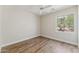 Bright bedroom with wood-look floors and a window overlooking the yard at 11008 N 119Th Pl, Scottsdale, AZ 85259