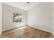 Bright bedroom with wood-look floors and a large window overlooking the yard at 11008 N 119Th Pl, Scottsdale, AZ 85259