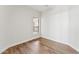 Empty room featuring hardwood floors, natural light, and neutral walls at 11008 N 119Th Pl, Scottsdale, AZ 85259