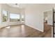 Bright bedroom with hardwood floors, a door to the outside, and views of the pool and landscaping at 11008 N 119Th Pl, Scottsdale, AZ 85259