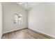 Bright bedroom with wood-look floors and a window overlooking the yard at 11008 N 119Th Pl, Scottsdale, AZ 85259