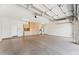 Spacious garage with bright lighting, epoxy floor, and ample storage space in the built-in cabinets at 11008 N 119Th Pl, Scottsdale, AZ 85259