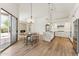 Bright, open kitchen with island, stainless appliances, and adjacent dining area with fireplace view at 11008 N 119Th Pl, Scottsdale, AZ 85259
