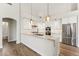 Bright kitchen featuring a large center island, stainless appliances, and modern pendant lighting at 11008 N 119Th Pl, Scottsdale, AZ 85259