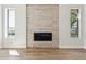 Bright living room with tile fireplace, wood floors, and windows with views at 11008 N 119Th Pl, Scottsdale, AZ 85259