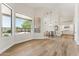 Open-concept living room with hardwood floors, high ceilings, and large windows with backyard views at 11008 N 119Th Pl, Scottsdale, AZ 85259