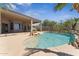 Inviting pool area with mature landscaping, rock waterfall, and stunning desert scenery at 11008 N 119Th Pl, Scottsdale, AZ 85259