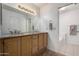 Bathroom featuring dual sinks, ample vanity storage, and bright vanity lighting at 11065 W Runion Dr, Peoria, AZ 85373