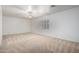 Bright bedroom with neutral carpet, ceiling fan, and shuttered window for natural light at 11065 W Runion Dr, Peoria, AZ 85373