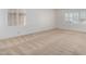 This expansive bedroom features neutral carpet, white walls, and two windows at 11065 W Runion Dr, Peoria, AZ 85373