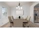 The dining room offers a chandelier over a table and chair set and is adjacent to the kitchen at 11065 W Runion Dr, Peoria, AZ 85373