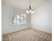 The dining room offers natural light and an overhead chandelier at 11065 W Runion Dr, Peoria, AZ 85373