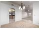 Bright dining area with a modern chandelier and neutral paint at 11065 W Runion Dr, Peoria, AZ 85373