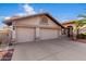 Charming home featuring a three-car garage, tiled roof, and desert landscaping at 11065 W Runion Dr, Peoria, AZ 85373
