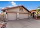 Charming home featuring a three-car garage, tiled roof, and desert landscaping at 11065 W Runion Dr, Peoria, AZ 85373