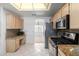 Kitchen with stainless steel appliances and oak cabinetry at 11065 W Runion Dr, Peoria, AZ 85373