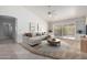 Bright living room featuring vaulted ceilings, neutral decor, and sliding doors to the outside at 11065 W Runion Dr, Peoria, AZ 85373