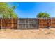 View of a wooden fence with a metal gate to the backyard at 1118 N 18Th St, Phoenix, AZ 85006