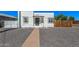 Charming white home featuring a black door, black trimmed windows, and desert landscaping at 1118 N 18Th St, Phoenix, AZ 85006
