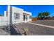 Charming white home featuring a black door, black trimmed windows, and desert landscaping at 1118 N 18Th St, Phoenix, AZ 85006