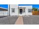 Charming white home featuring a black door, black trimmed windows, and desert landscaping at 1118 N 18Th St, Phoenix, AZ 85006