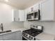 Close-up of the kitchen area with quartz countertops and stainless steel gas range at 1118 N 18Th St, Phoenix, AZ 85006