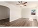 Bright living room featuring new light-colored walls, wood floors, and a ceiling fan at 1118 N 18Th St, Phoenix, AZ 85006