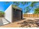 A dark brown shed door in the backyard with rocks at the base at 1118 N 18Th St, Phoenix, AZ 85006