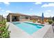 Lovely backyard with a pool, artificial turf, fire pit and lounge seating, perfect for entertaining or relaxing at 11951 W Wier Ave, Avondale, AZ 85323