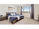 Bedroom with large window, carpeted floors, and contemporary furnishings at 11951 W Wier Ave, Avondale, AZ 85323