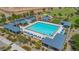 Large community pool surrounded by lounge chairs and shaded seating areas at 11951 W Wier Ave, Avondale, AZ 85323