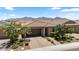 Charming single-Gathering home with a tile roof, desert landscaping, and a brick driveway leading to a two-car garage at 11951 W Wier Ave, Avondale, AZ 85323