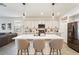 Bright kitchen boasts a large island with seating, white cabinets and stainless steel appliances at 11951 W Wier Ave, Avondale, AZ 85323