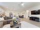 Open concept living room with tile floors and ample seating at 11951 W Wier Ave, Avondale, AZ 85323