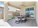 Inviting outdoor patio with ceiling fan, outdoor kitchen and large sliding glass door leading to the house at 11951 W Wier Ave, Avondale, AZ 85323