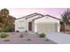 Charming single-story home with a well-manicured front yard, neutral color palette, and an attached two-car garage at 12550 W Luxton Ln, Avondale, AZ 85323