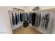Functional walk-in closet with ample storage space and organized hanging racks at 12550 W Luxton Ln, Avondale, AZ 85323