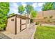 Exterior image of a backyard shed with rock landscaping and a grassy lawn at 12932 W Cassia Trl, Peoria, AZ 85383