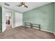 Bright bedroom features a ceiling fan, carpet flooring, and large closet doors at 12932 W Cassia Trl, Peoria, AZ 85383