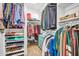 Well-organized walk-in closet with ample storage and custom shelving and hanging racks at 12932 W Cassia Trl, Peoria, AZ 85383