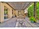 Covered patio features a built-in sun shade, pavers, and an outdoor dining table at 12932 W Cassia Trl, Peoria, AZ 85383