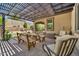 Covered patio features an outdoor dining area, pavers, and a shade structure at 12932 W Cassia Trl, Peoria, AZ 85383