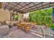 Covered patio features an outdoor dining area, pavers, and a shade structure at 12932 W Cassia Trl, Peoria, AZ 85383