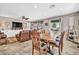 Open-concept dining room adjacent to the living room with backyard views through sliding glass door at 12932 W Cassia Trl, Peoria, AZ 85383