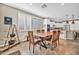 Dining room features large wood table and plantation shutters with view to kitchen at 12932 W Cassia Trl, Peoria, AZ 85383
